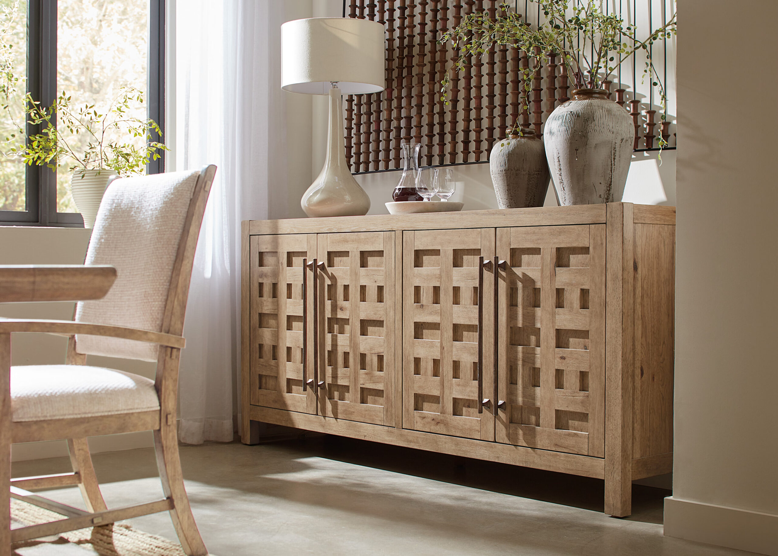 Hooker Furniture Vineyard Row Buffet with Pecky Hickory and White Oak veneers in Sonoma finish. Features honey gray travertine top, four soft-close doors, two self-closing drawers, and adjustable wood shelves. Rustic metal hardware.