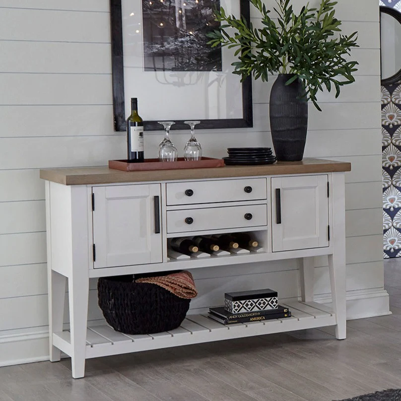 Parker House Americana Modern Dining Sideboard, 54"x19", crafted from poplar solids and birch veneers with a hand-painted Cotton finish and contrasting Weathered Natural top. Features burnished bronze hardware, dual AC power center, two storage drawers with English dovetail joinery, open slatted shelf, wine bottle rack, and concealed storage behind doors. Perfect for dining and entertaining.