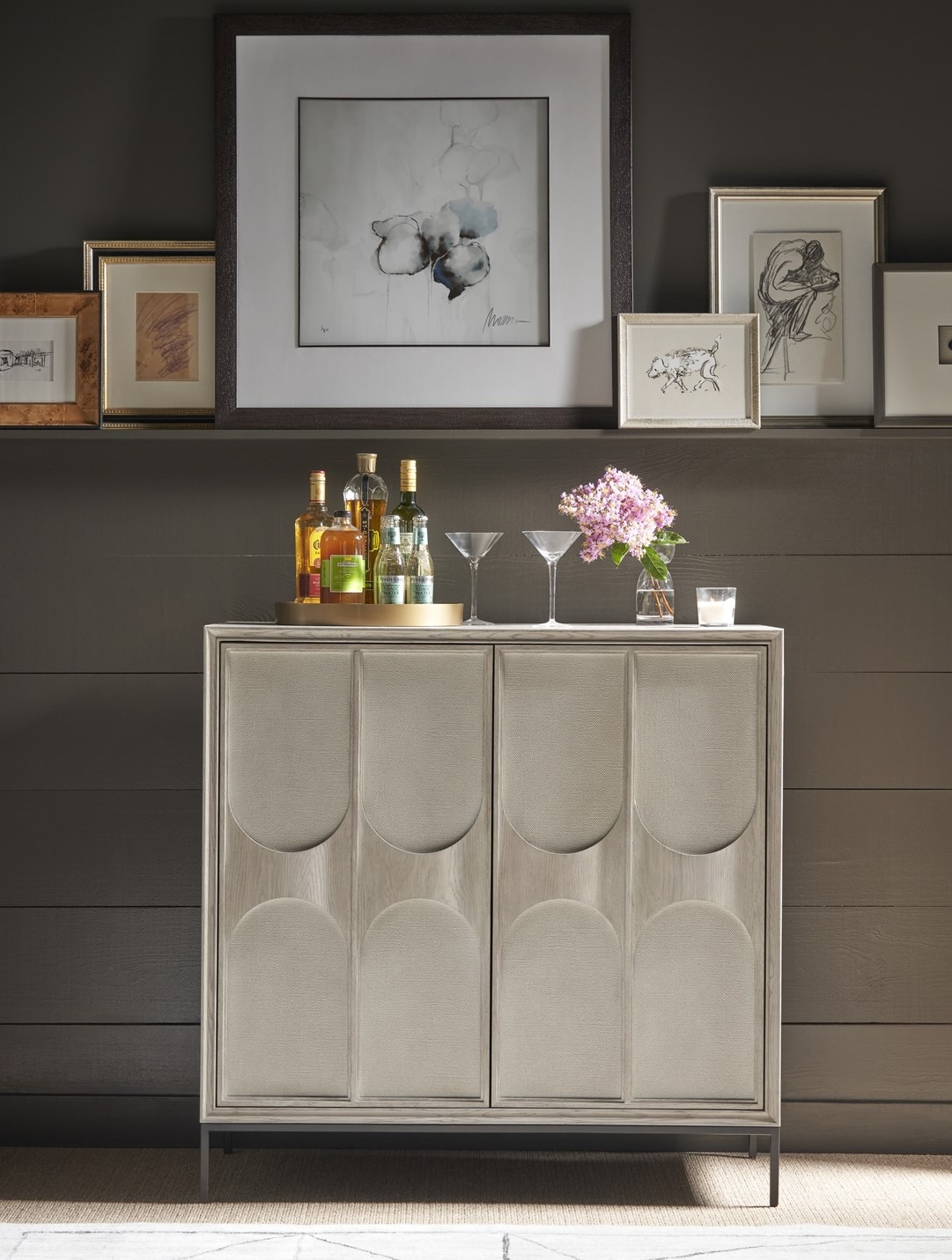 Universal Odessa Bar Cabinet with faux linen texture door fronts and Rolling Fog finish. A contemporary design that adds a refined, modern touch to any entertainment space. Dimensions: 42W x 19D x 42H.