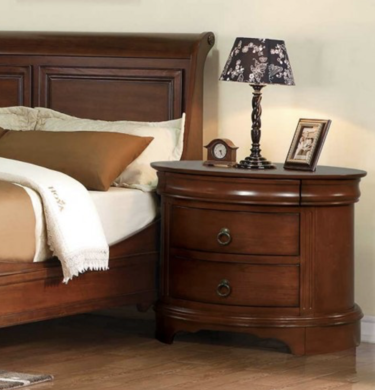 The 30" 3-Drawer Oval Nightstand is beautifully crafted from cherry veneer, engineered wood, and solid hardwood. It features a hand-rubbed finish, ball bearing drawer glides, dovetail drawer construction, and a hidden felt-lined top drawer. Two lower drawers offer additional storage, and a bottom dust cover adds durability.