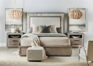 Beautiful neutral-toned bedroom with wood-accented bed, nightstands, and soft lighting, featuring cozy linens and modern décor.