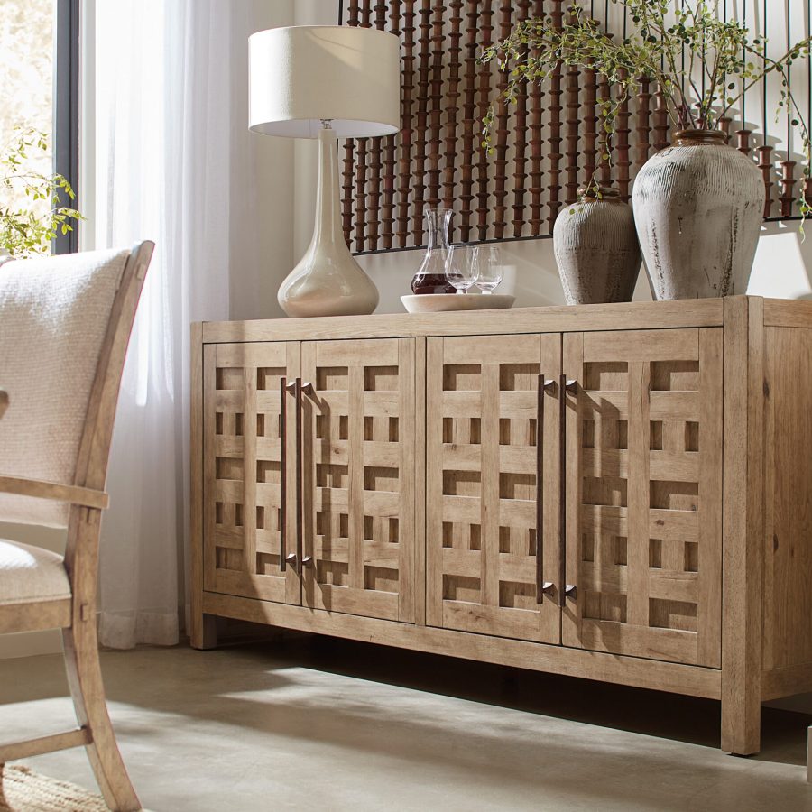 Hooker Furniture Vineyard Row Buffet with Pecky Hickory and White Oak veneers in Sonoma finish. Features honey gray travertine top, four soft-close doors, two self-closing drawers, and adjustable wood shelves. Rustic metal hardware.