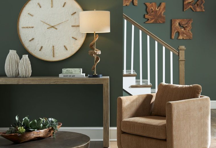 Modern living space with wooden wall decor pieces, a large clock, a sleek console table, and a cozy armchair.