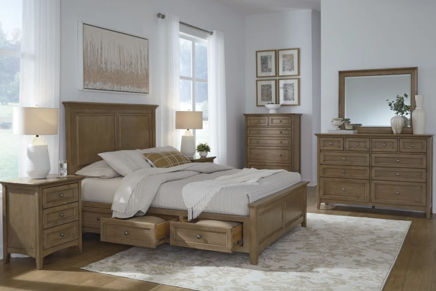 Elegant Whittier Wood bedroom set featuring a storage bed, nightstands, dresser with mirror, and tall chest in a warm wood finish.