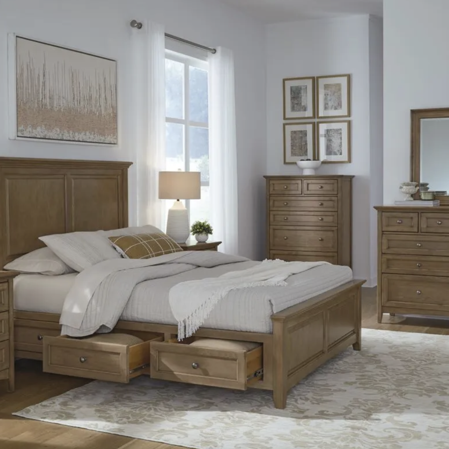 Elegant Whittier Wood bedroom set featuring a storage bed, nightstands, dresser with mirror, and tall chest in a warm wood finish.